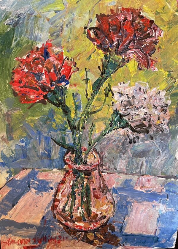 Carnations in small glass vase